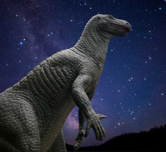 Ein Dinosaurier (Iguanodon) vor einem Sternenhimmel